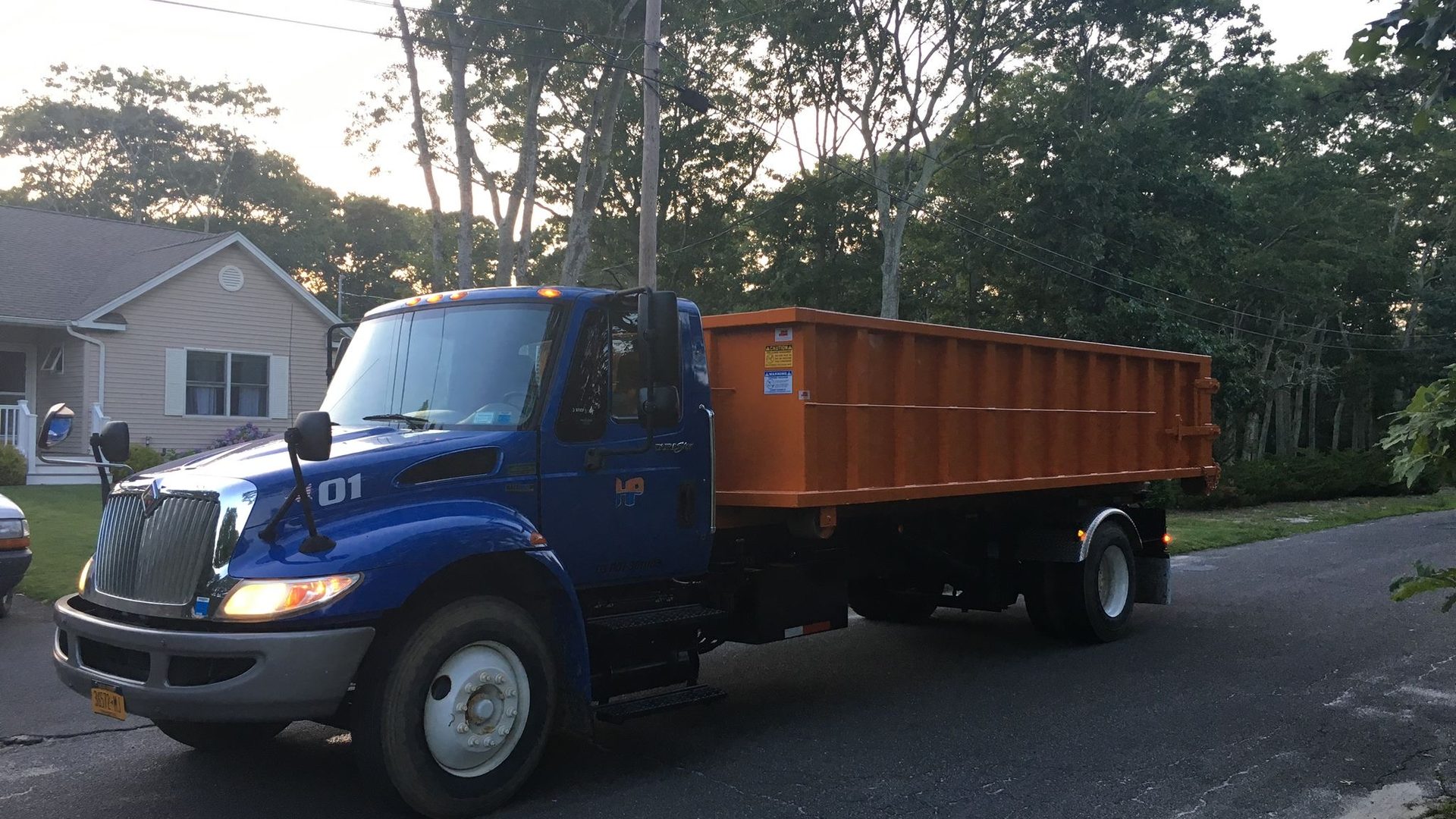 A Hamptons Pick Up roll-off dumpster truck on a job in Amagansett, NY