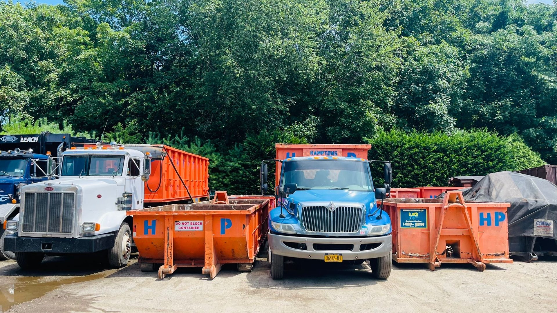 A Hamptons Pick Up roll-off dumpster truck on a job in Aquebogue, NY