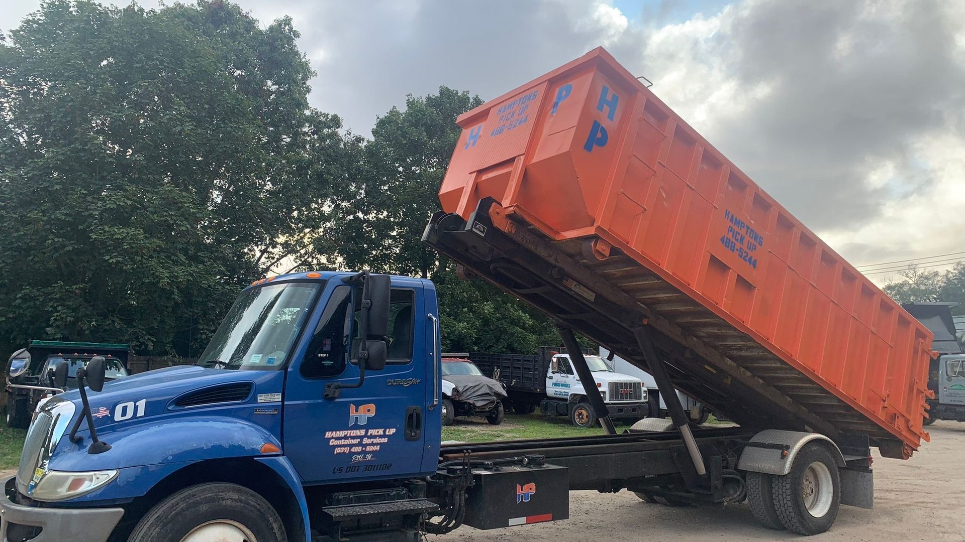 A Hamptons Pick Up roll-off dumpster truck on a job in East Hampton, NY