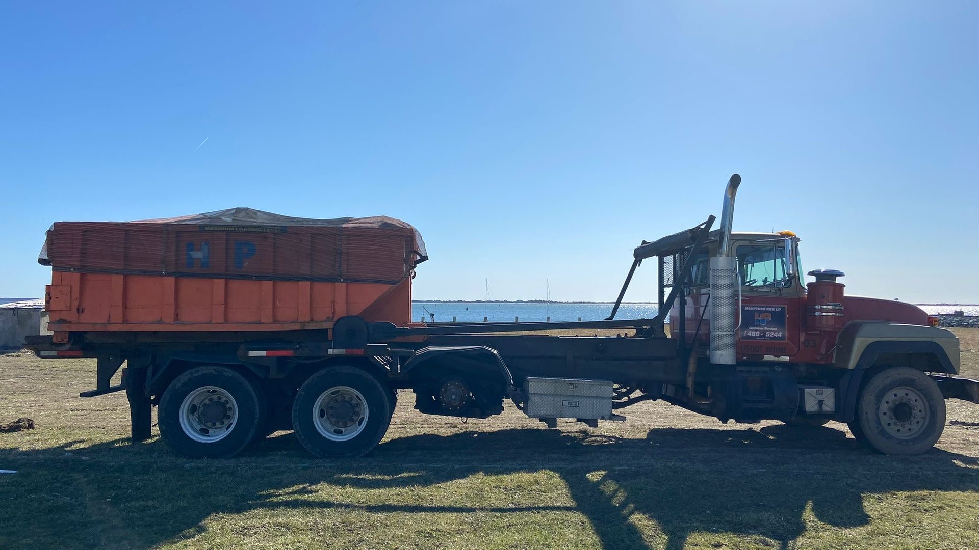 A Hamptons Pick Up roll-off dumpster truck on a job in Hampton Bays, NY