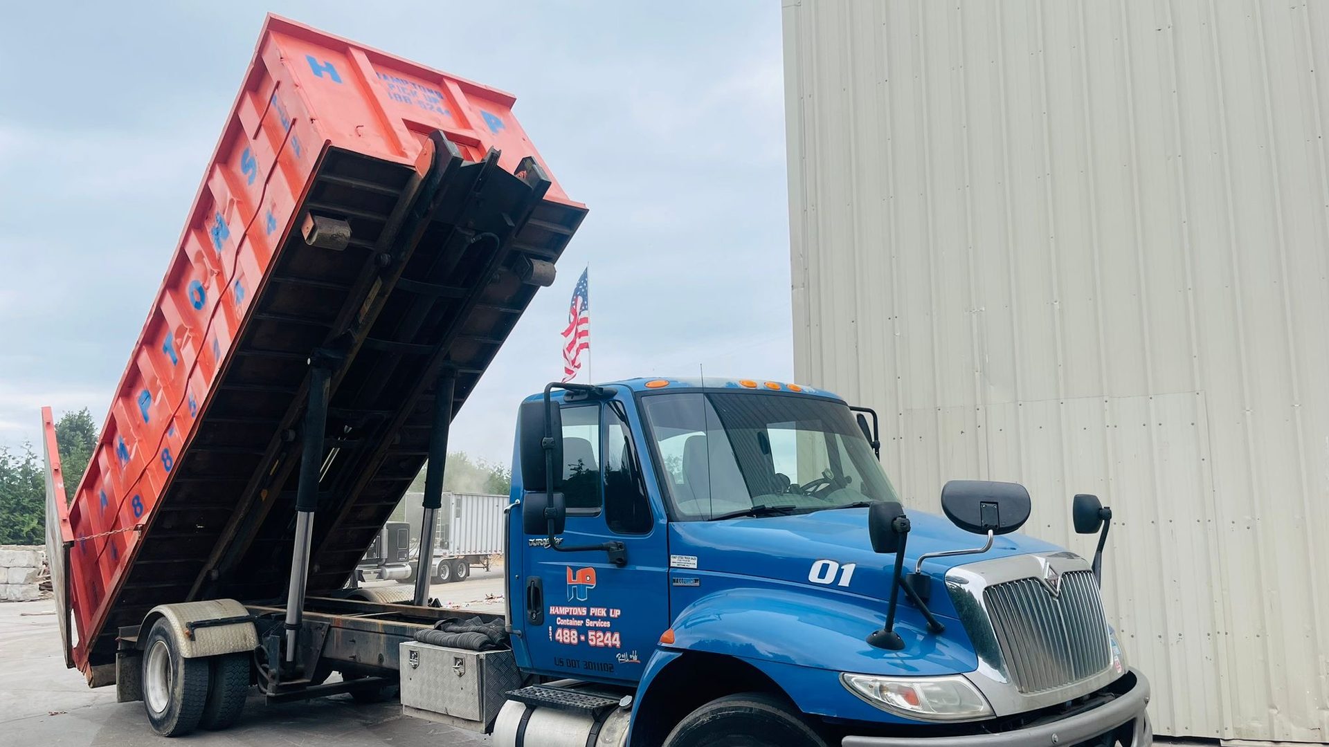 A Hamptons Pick Up roll-off dumpster truck on a job in Mattituck, NY