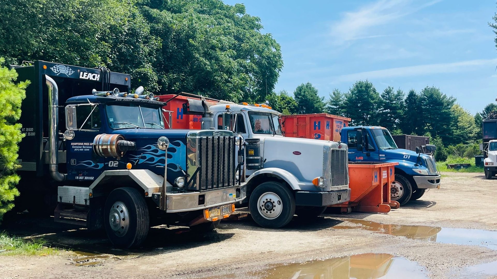 A Hamptons Pick Up roll-off dumpster truck on a job in Riverhead, NY