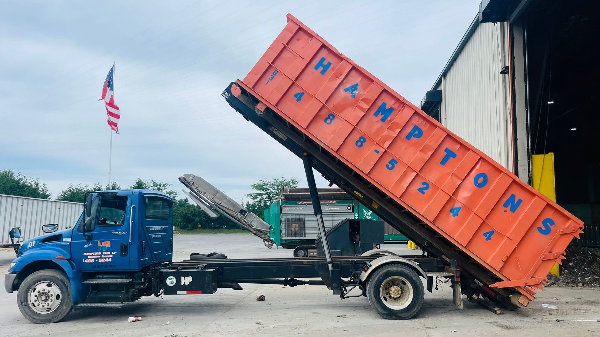 A Hamptons Pick Up roll-off dumpster truck on a job in Southampton, NY