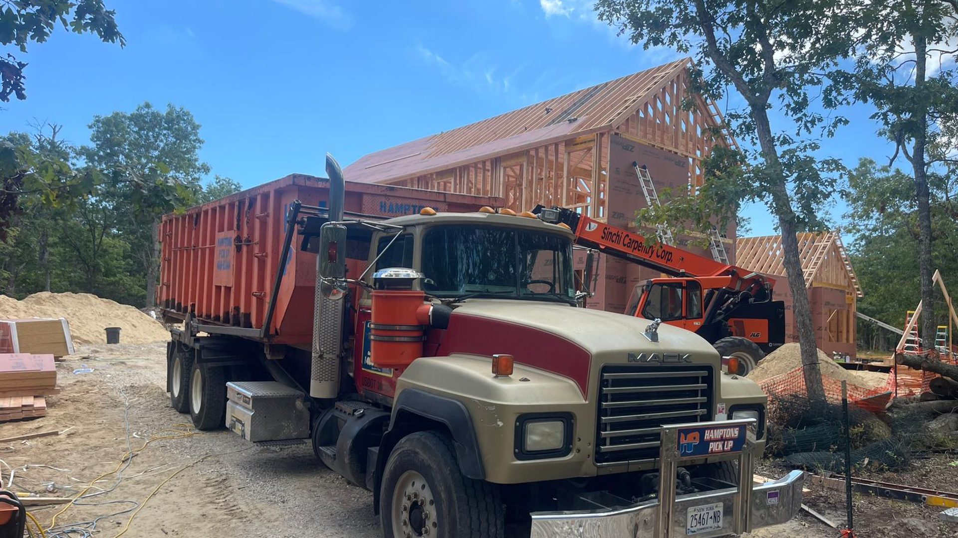 A Hamptons Pick Up roll-off dumpster truck on a job in Southold, NY
