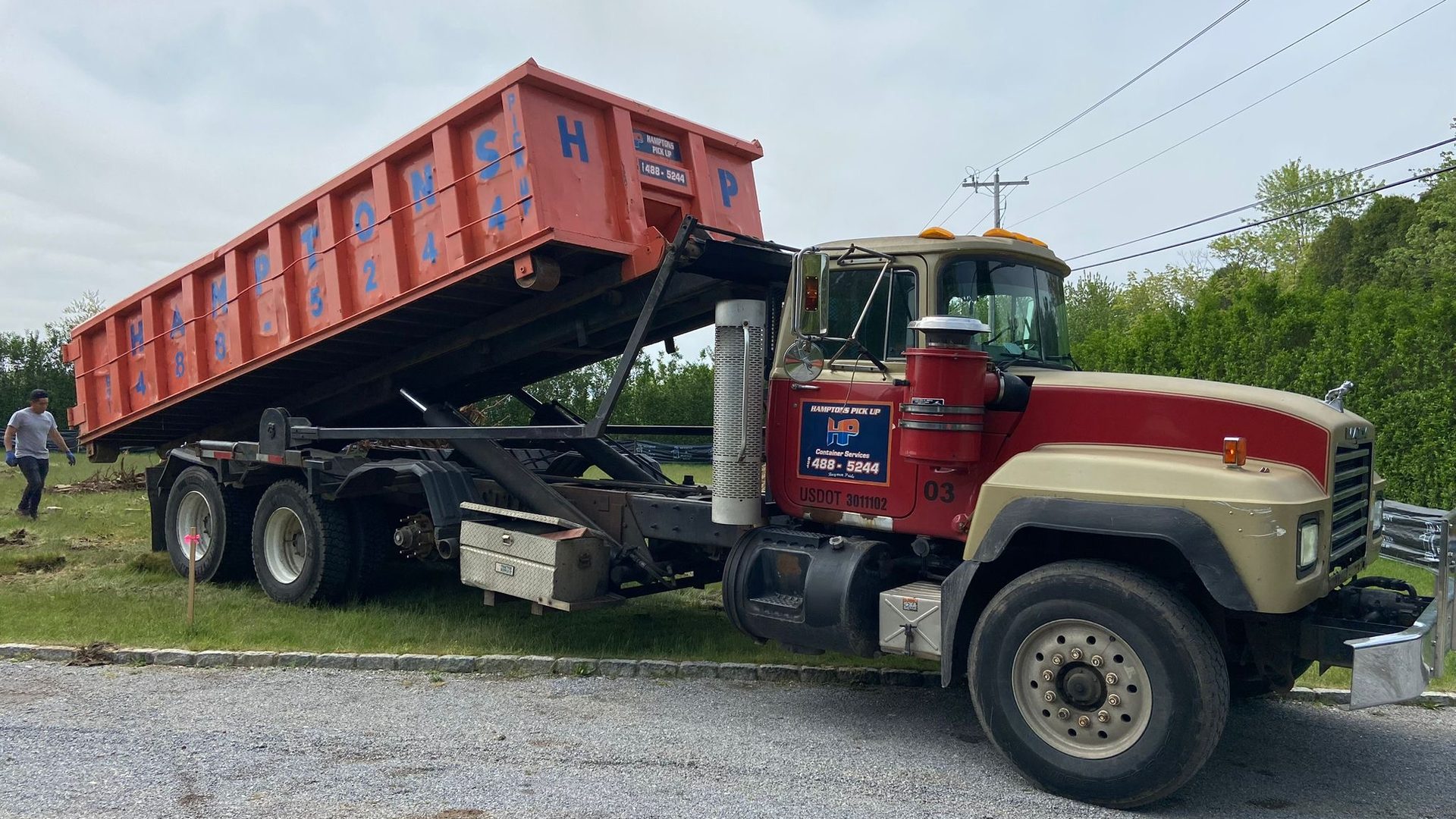 A Hamptons Pick Up roll-off dumpster truck on a job in Westhampton, NY